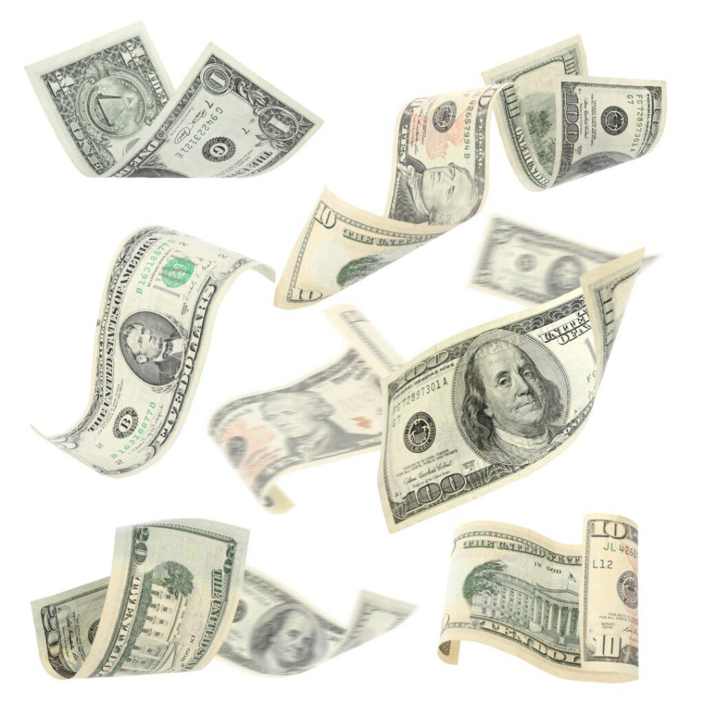 Floating U.S. dollar bills of various denominations on a white background, symbolizing financial transactions and transfer pricing trends.