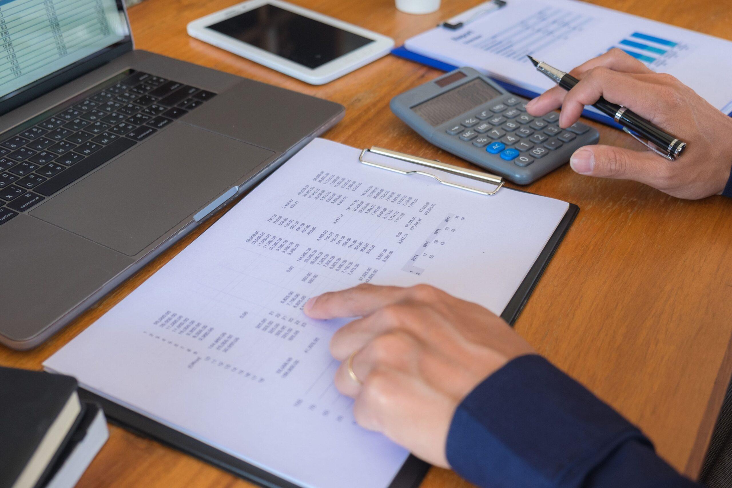 Close-up of a person flipping through a thick book, representing research and preparation for transfer pricing documentation requirements.