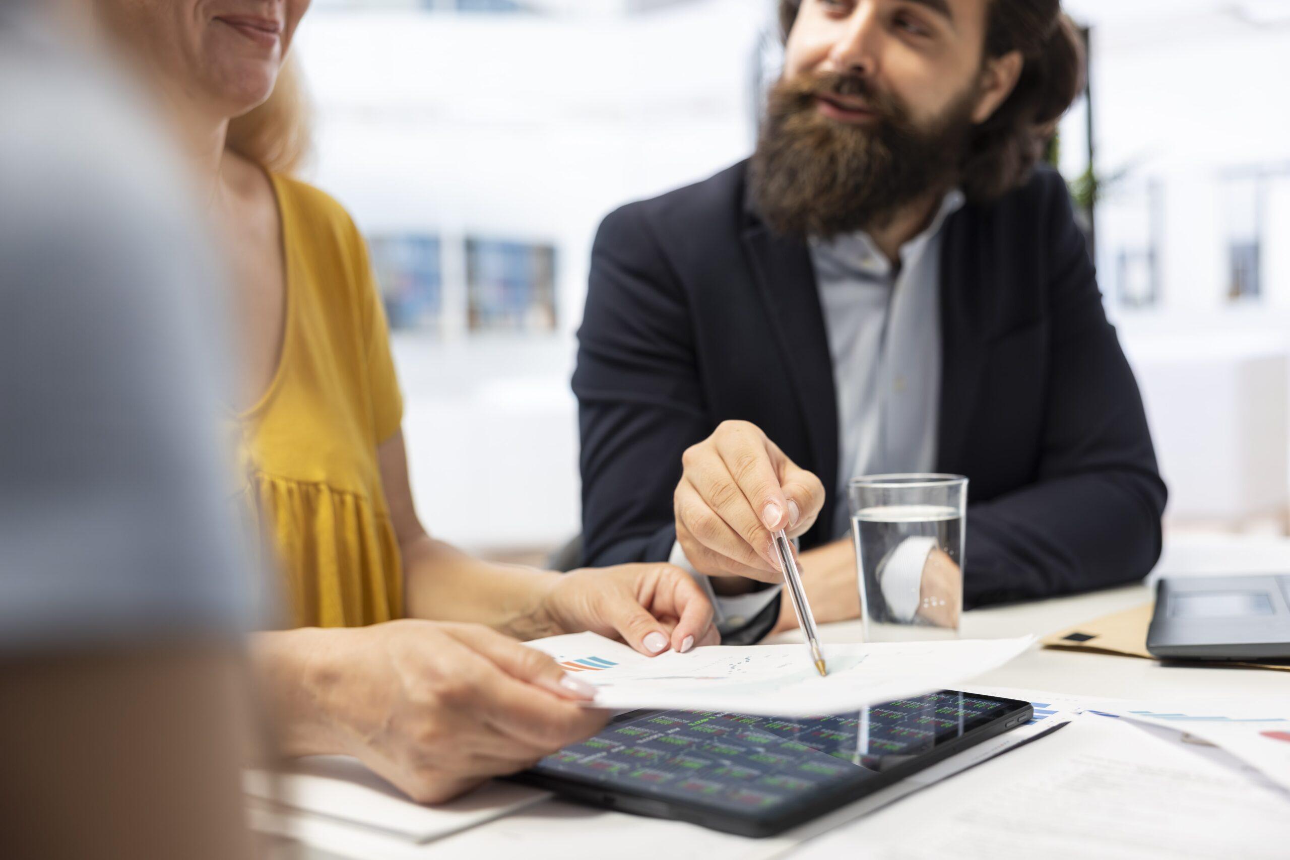 Two business professionals reviewing printed documents, representing transfer pricing documentation requirements.
